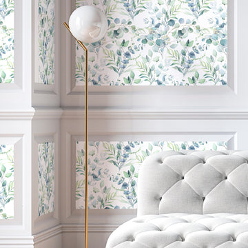 Eucalyptus peel and stick wallpaper in wainscot panels with floor lamp and tufted chair — sophisticated install rivaling traditional wallpaper