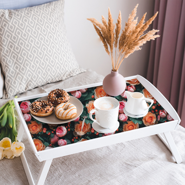 A white folding bed tray with its flat base lined in Fresh Roses peel and stick paper, set with a plate of donuts, a cappuccino, a creamer and a pink vase of dried pampas grass.