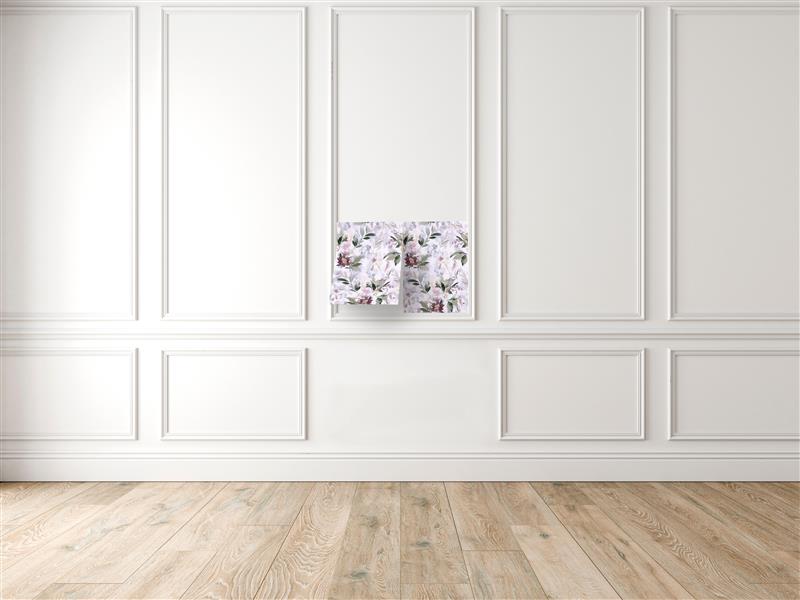 Two floral peel and stick wallpaper sheets in lilac, green and plum tones side by side on a white paneled wall, their lower edges lifting slightly, above a light oak floor