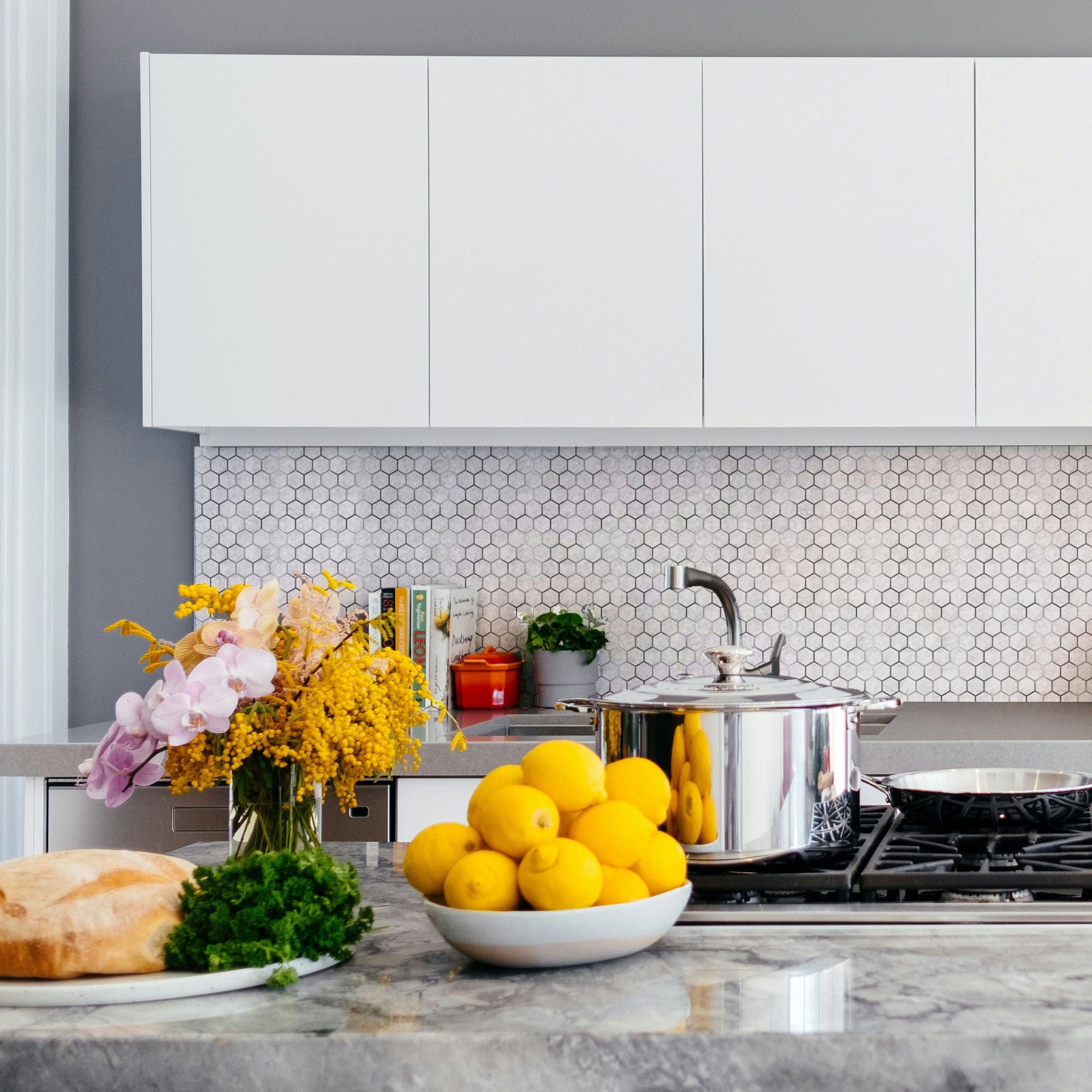 Marble Silver Hexagon peel and stick tile installed as a bathroom vanity backsplash with sink and mirror — actual bathroom in-use shot