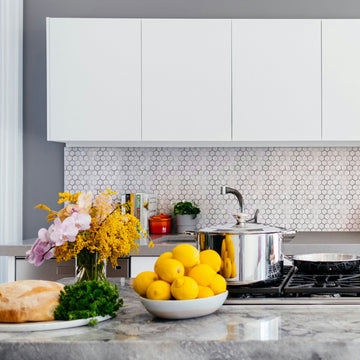 Marble Silver Hexagon peel and stick tile installed as a bathroom vanity backsplash with sink and mirror — actual bathroom in-use shot