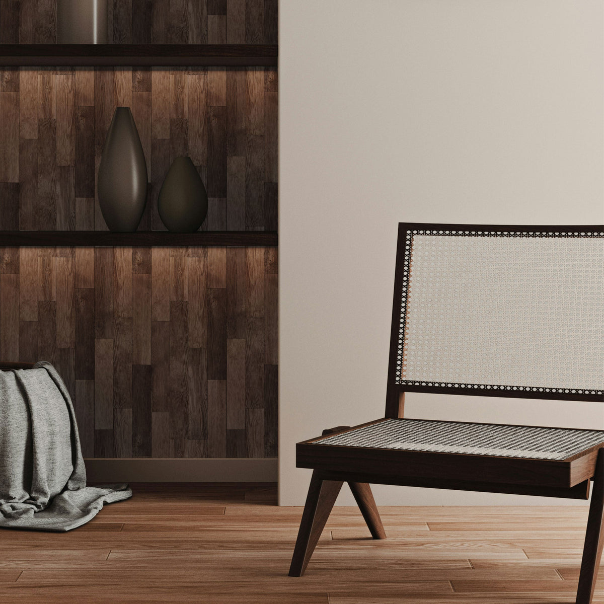 Built-in shelving with its back panel lined in dark wood-look peel and stick paper, holding two dark ceramic vases, beside a cane-backed bench.